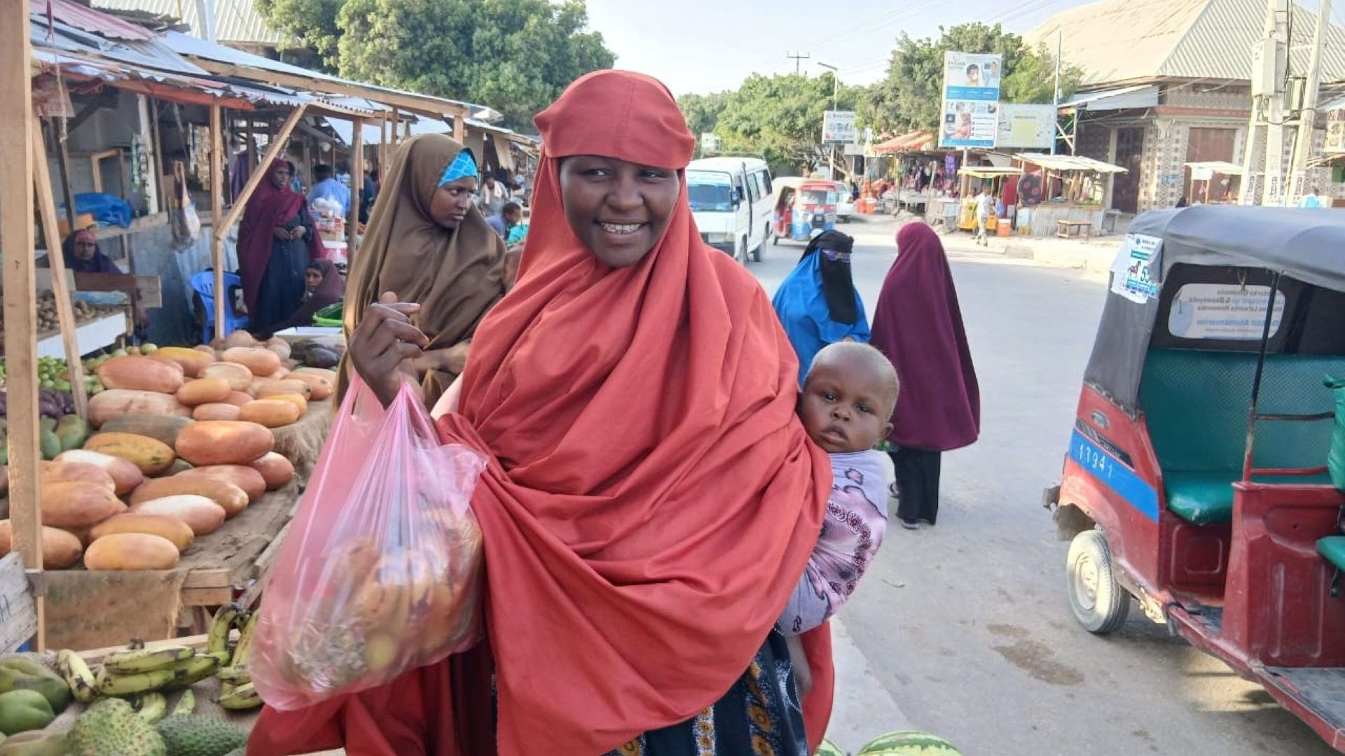 Maryan from Somalia buys food with emergency cash.