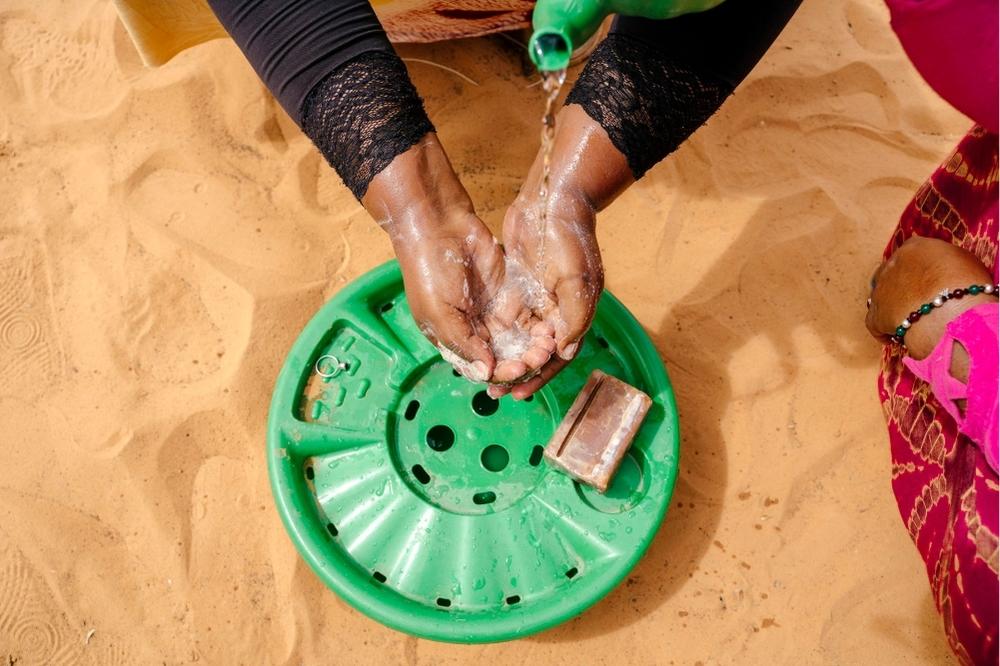 A person washing their hands