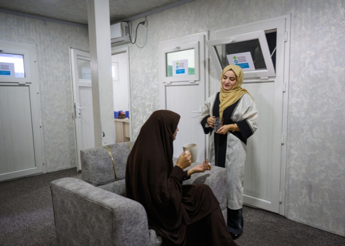 Two psychologists talk in waiting room in Afghanistan.
