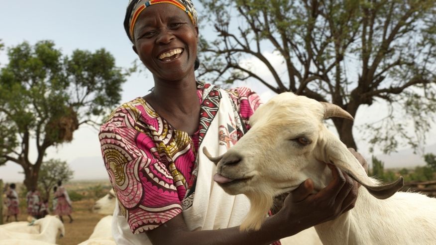 A woman holding a goat