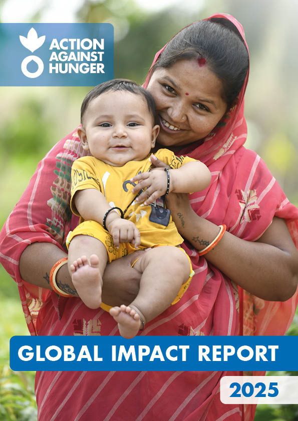 Front cover of Action Against Hunger Global Impact Report with mother with headscarf holding baby.