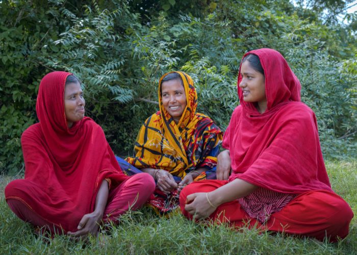 Three women taking part in women's group in Bangladesh.