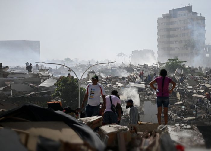 Volunteers search for survivors in a collapsed building following the twin earthquakes in La Guaira state, Venezuela.