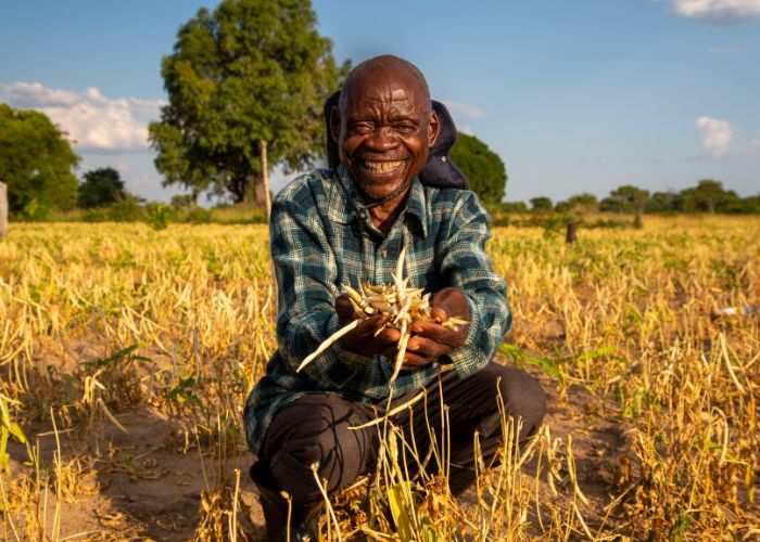 Sitwala, a farmer from Tanzania, holding handful of cow peas.